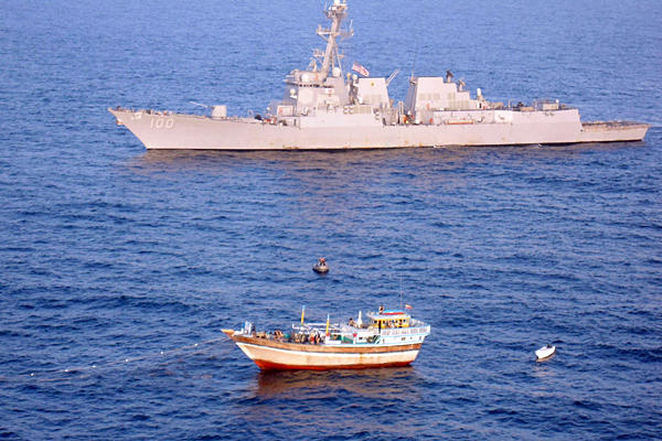 In 2011, the foreign navies amassed around the Horn of Africa and NW Indian Ocean moved away from playing a losing game of catch-up against Somali pirates and went instead to a game of offensive defense. Meaning that surveillance was increased, and suspiciously acting dhows towing skiffs, as well as other odd behavior by fishing boats was tracked and in the most glaring cases a warship was sent to go inspect. In this case we see a dhow towing a skiff that's been stopped by a USN warship - a team is moving towards the dhow, while the cameraman sits in a helicopter that likely carries a marksman with a large caliber sniper rifle who is providing cover for the inspection team. This new strategy by the navies has been one of the main reasons - along with greater numbers of merchant vessels respecting BMP4 and more armed guards on board ships - Somali pirates have had to change their game and get a lot craftier.