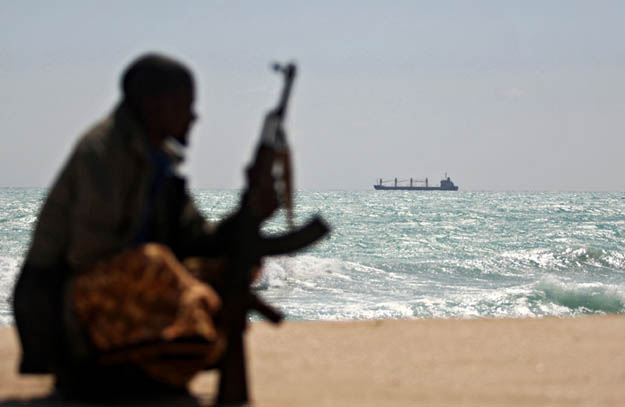 A Somali pirate poses
dramatically in front of a hijacked ship. The real threat for him comes not from foreign navies or
local authorities, but more from other gangs preferring to hijack ships from rival pirates. Modern
Somali piracy is a low risk, high payout deal - and so won't be gotten rid of, even if the current
crop of pirates is imprisoned or lost at sea or even killed in action. A new crop will just take their
place. To succeed, any global anti-piracy strategy must understand how and why Somalis
conduct piracy - it must attrit the business model of the most successful pirate entrepreneurs
first, and then slowly roll back pirates to raiding closer to Somalia.