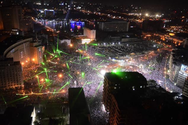 Pursuant to General al Sisi's call for massive peaceful protests against violence and terrorism, on Friday July 26 millions of Egyptians showed up. Here we see Tahrir square. The green lights are lasers that the demonstrators started using on June 30th. American built Apache helicopters flew over the crowd and were cheered by the crowds, who painted the copters with their lasers. Other protests later that night weren't as jovial or peaceful: pro-Morsi protestors tried moving over to a bridge and the worst violence so far occurred since the military intervened.